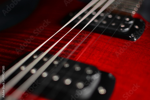 closeuup of atmospheric musicinstrument with colorful electric guitar on blue background