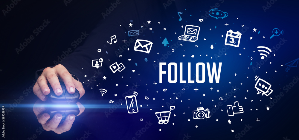 hand holding wireless peripheral with FOLLOW inscription, social media concept hand holding wireless peripheral with FOLLOW inscription, social media concept
