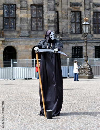 Figure of a death with a scythe in the city square in Amsterdam