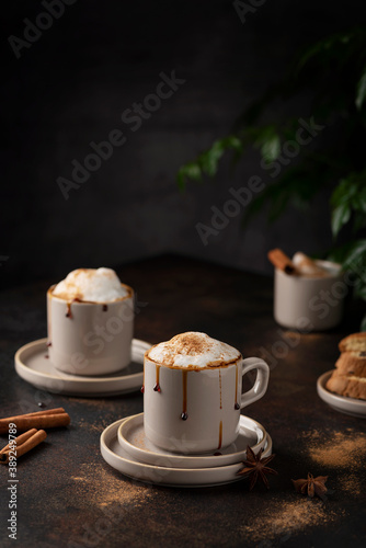 Hot winter cappuccino with cinnamon and caramel