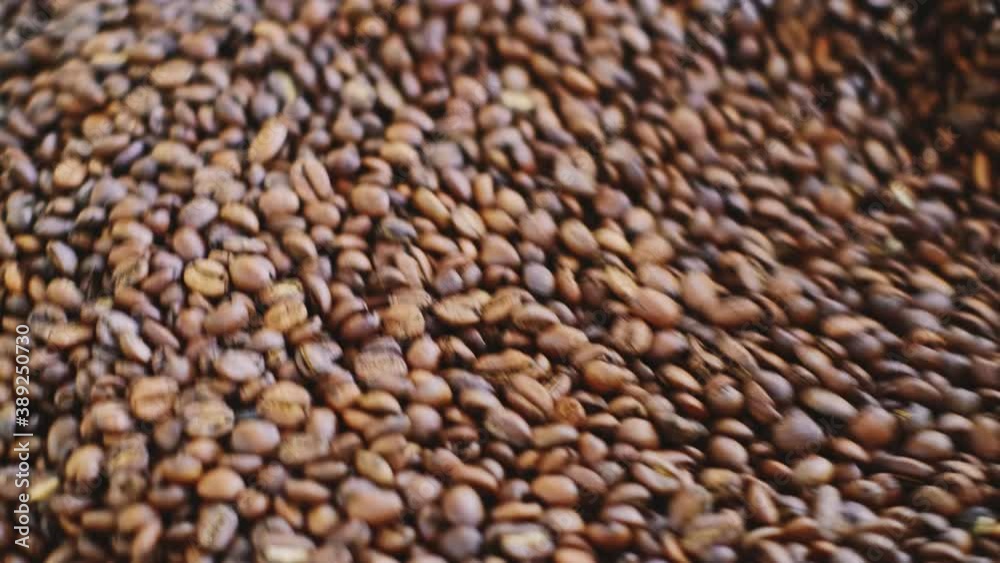 Roasted coffee beans in a cooler mixer closeup. Roasted coffee beans in a cooler mixer closeup.