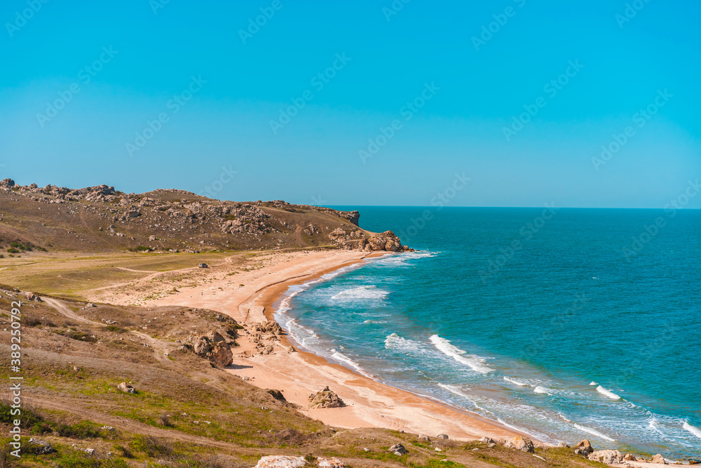 Sea coast with rocks in the water and waves, a delightful panoramic shot on a trip