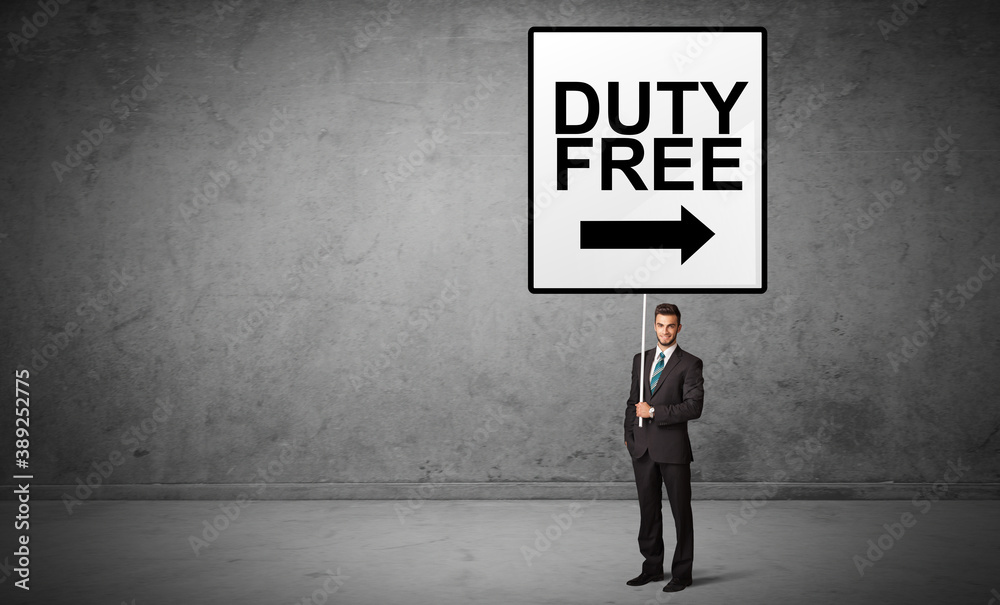 business person holding a traffic sign with DUTY FREE inscription, new idea concept business person holding a traffic sign with DUTY FREE inscription, new idea concept