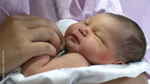 New Born Baby Girl Is Holding onto Mother's Finger
