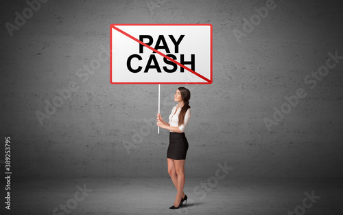 business person holding a traffic sign with PAY CASH inscription, new idea concept