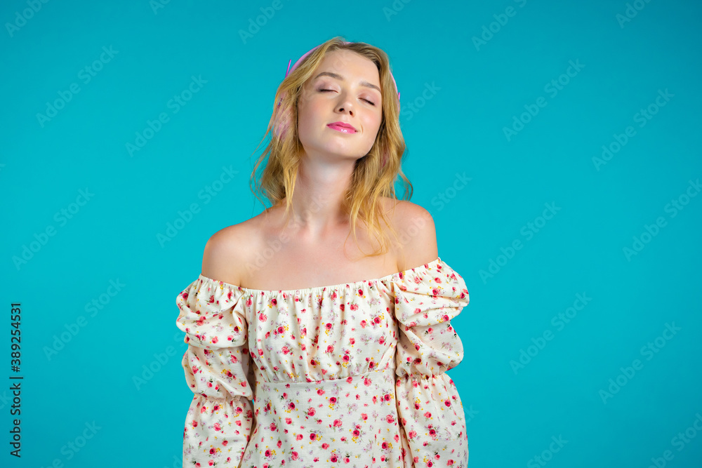 Attractive woman with blonde hair in headphones on blue studio background. Cute girl portrait. Music, radio, happiness, freedom, youth concept. Attractive woman with blonde hair in headphones on blue studio background. Cute girl portrait. Music, radio, happiness, freedom, youth concept.