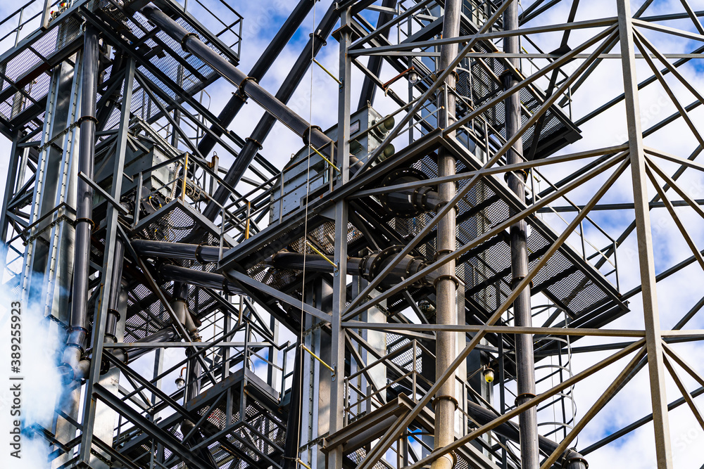 Wireframe in the plant. Steel construction near grain elevators. Selective focus from below.