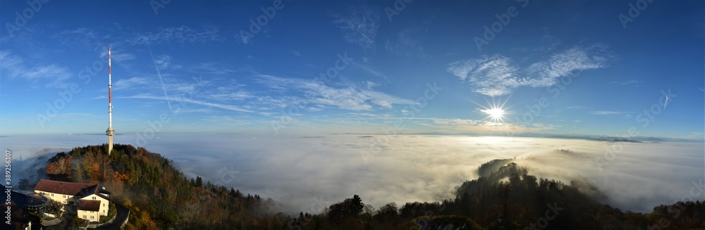 Fototapeta premium Panorama from the sea of fog from the Uetliberg on a beautiful autumn day. With television tower