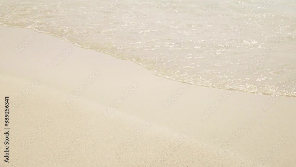 Oncoming waves on the sandy seashore