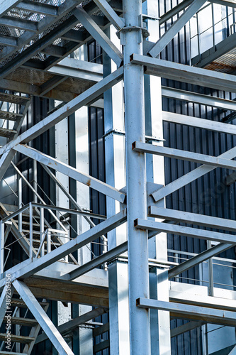 Metal stairs at factory. Steel construction at plant. Modern equipment and onterior. Closeup.