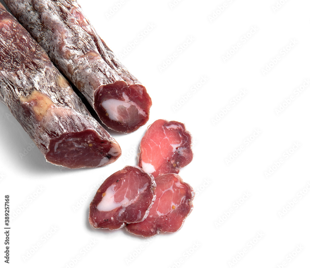 Dried sausage sliced into slices on a white plate. Elite meat product