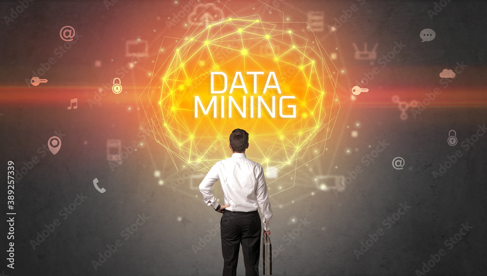 Rear view of a businessman with DATA MINING inscription, online security concept Rear view of a businessman with DATA MINING inscription, online security concept