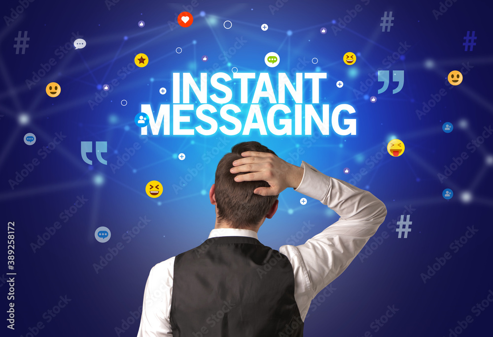 Rear view of a businessman with INSTANT MESSAGING inscription, social networking concept Rear view of a businessman with INSTANT MESSAGING inscription, social networking concept