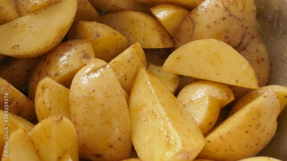 Raw potatoes mixed with spices Raw potatoes mixed with spices