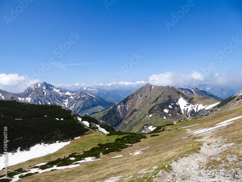 A panoramic view on a massive, stony mountains in Hochturm region, Austrian Alps. There are endless mountains chains in the back. The slopes are overgrown with moss and grass. Sunny and bright day. photo