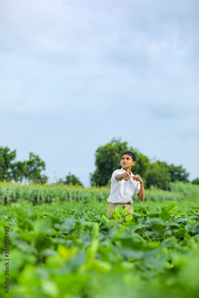 dreams of flight! indian child playing with toy airplane at green field dreams of flight! indian child playing with toy airplane at green field