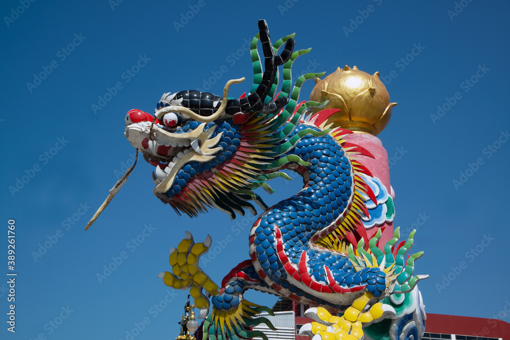 The pillars with stucco dragons wrapped around them are the art of Chinese shrines.. The pillars with stucco dragons wrapped around them are the art of Chinese shrines..