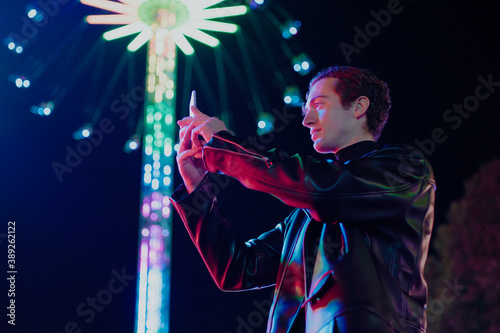 Attractive Man Take Photo of Sparkling Carousel