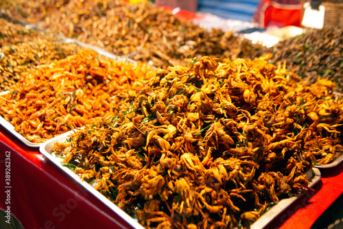 Worms and fried insects Spicy stir-fry at a market in Thailand that is Thai food. And has a lot of natural proteins.