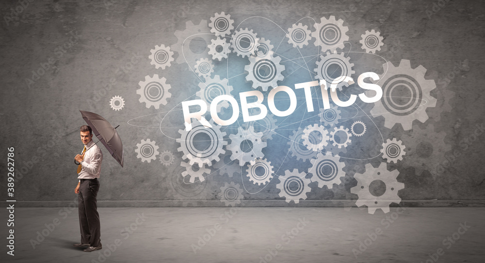 Businessman defending with umbrella from ROBOTICS inscription, technology concept Businessman defending with umbrella from ROBOTICS inscription, technology concept