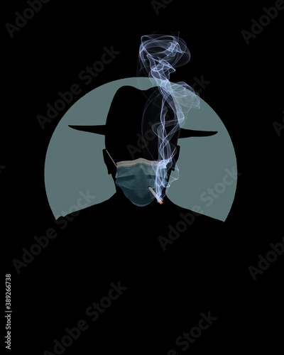 A man in a fedor smokes a cigarette through a hole in his surgical mask that he is wearing for protection from Covid-19. Illustrates health concerns that are ignored during pandemic. photo