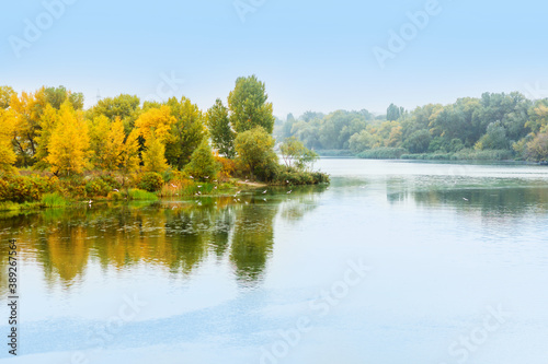 River water landscape. Forest river in autumn. Forest lake view. Autumn forest river refelction in water. Autumn nature forest river landscape. Lake water reflection in autumn.