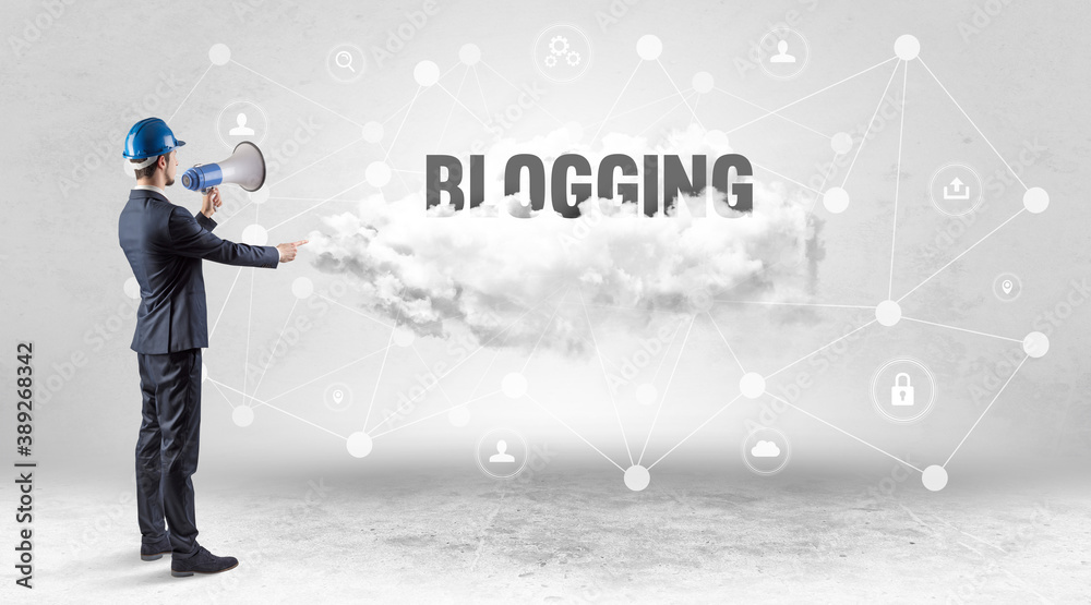 Engineer working on a social media concept with BLOGGING inscription Engineer working on a social media concept with BLOGGING inscription