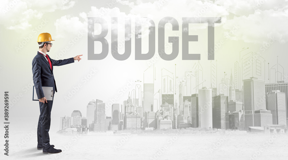 Young businessman with hard hat and BUDGET inscription, new business opportunity concept