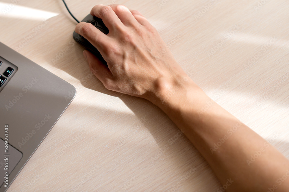 Female hand with a hygroma. Pain. Wrist ganglion cyst. Computer mouse