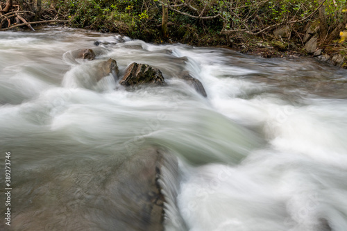 Long exposure of the river Heddon flowing through the woods at Heddons mouh in Exmoor photo