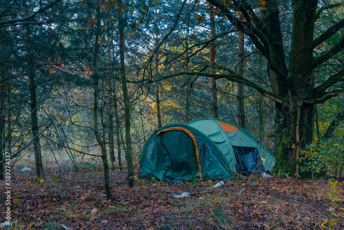 The tent of a homeless person in a forest in Berlin, the tent of a homeless person with some garbage around it