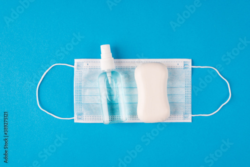 Lets stop the disease. Top above overhead close up flat lay view photo of protective equipment bar of soap sanitizing spray for hands and medical mask isolated vivid color background