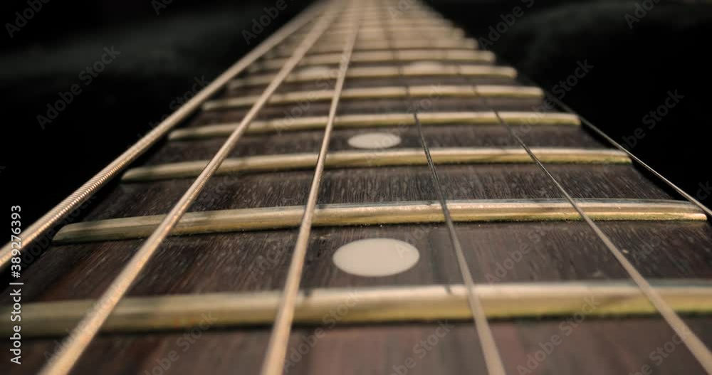 Acoustic guitar fretboard macro closeup slider shot Acoustic guitar fretboard macro closeup slider shot