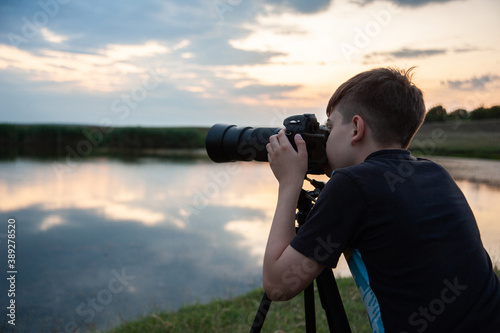 Photo of a boy holding a camera and taking some photos