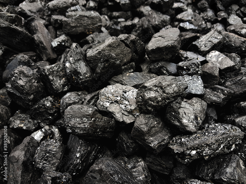 Natural black coals background texture. Top view of fuel for industrial coal