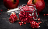 Some healthy preserved Pomegranate seeds (selective focus; close-up shot)