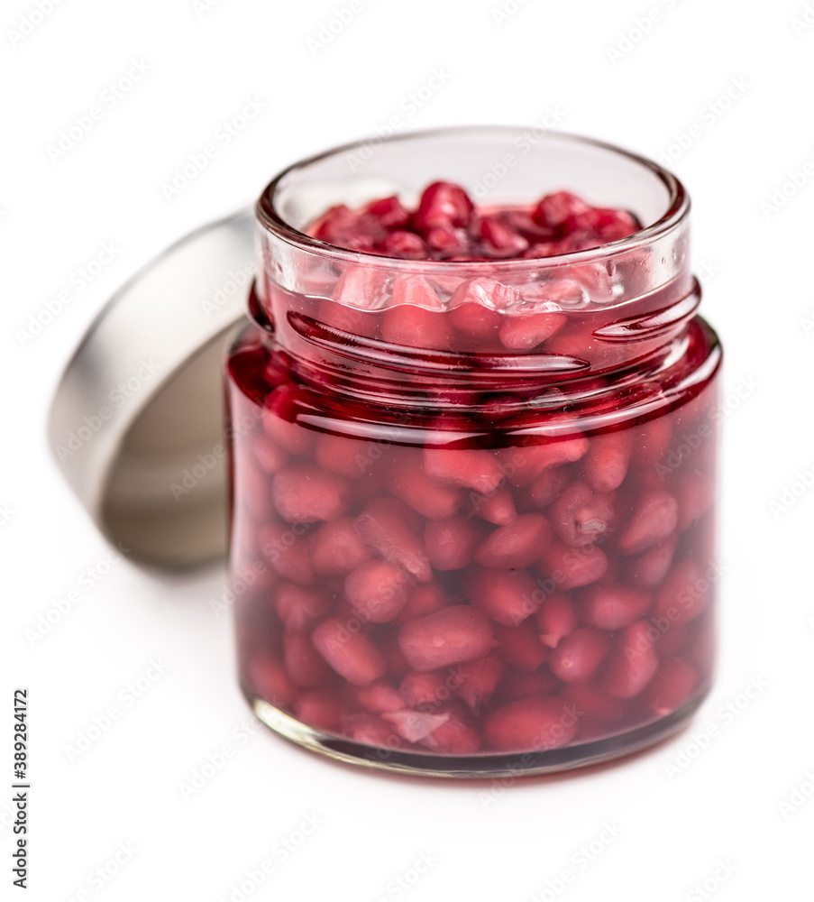 Portion of preserved Pomegranate seeds isolated on white background (selective focus). Portion of preserved Pomegranate seeds isolated on white background (selective focus).