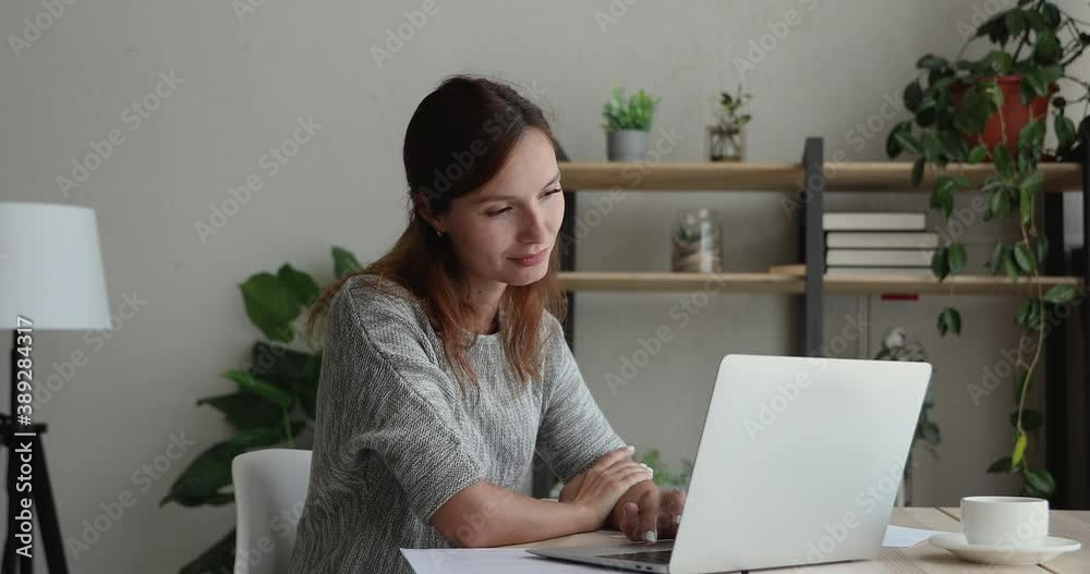 Distracted from study or work young bored woman web surfing information on website, scrolling social networks pages. Smiling businesswoman finding problem solution, feeling satisfied at home office. Distracted from study or work young bored woman web surfing information on website, scrolling social networks pages. Smiling businesswoman finding problem solution, feeling satisfied at home office.