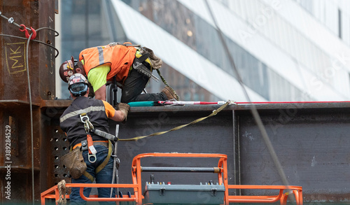2 Steel framers at work on the erecting of a hi-rise building in Manhattan’s Hudson Yards development photo