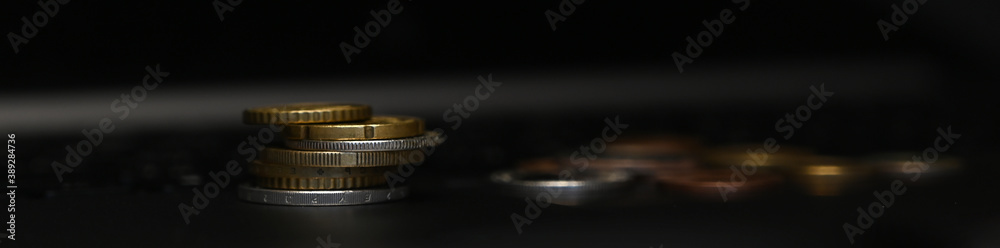 Closeup of three stacks of silver coins on laptop. Closeup of three stacks of silver coins on laptop.