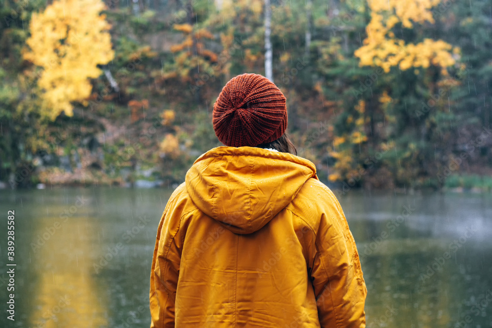 Girl in a yellow jacket and brown hat.