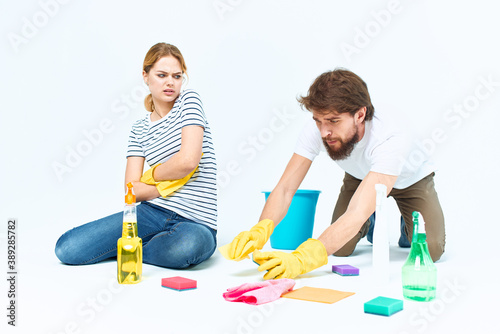 Young couple wash floors at home interior light background lifestyle