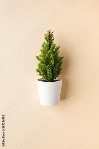 Christmas tree on a beige background. Minimal holiday concept. Copy space.