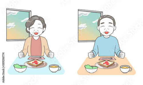 笑顔で朝食を食べる　高齢者