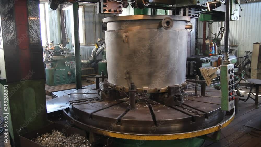 Metal fiber is rotating around big drill of steel metal lathe machine engine, technology manufacturer in operation process in industry manufacturing plant factory. Raw product equipment in warehouse. Metal fiber is rotating around big drill of steel metal lathe machine engine, technology manufacturer in operation process in industry manufacturing plant factory. Raw product equipment in warehouse.