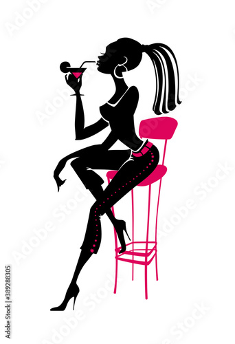 Girl sitting on a bar stool with a cocktail glass.