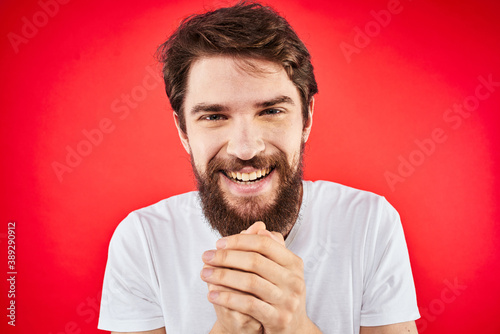 Bearded man fun emotions lifestyle cropped view white t-shirt red background