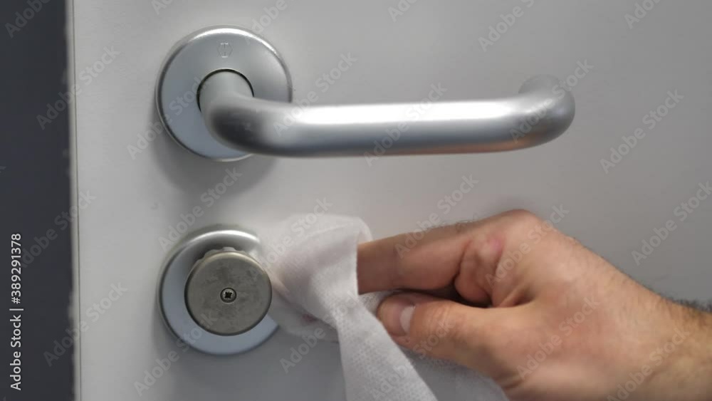 Man Wipes School Entrance Door Handle With Wet Disinfectant Wipe, CoronaVirus Man Wipes School Entrance Door Handle With Wet Disinfectant Wipe, CoronaVirus