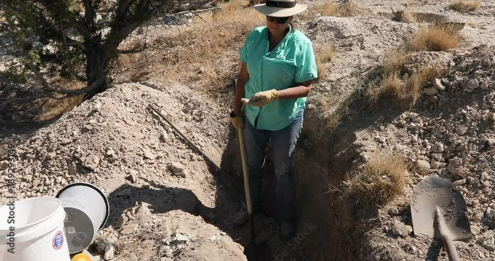 Woman mining digging shovel for rocks hobby 4K. Digging and collecting