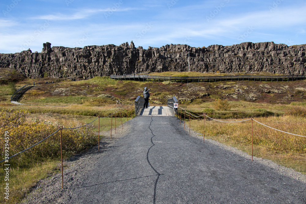 THINGVELLIR NATIONAL PARK, ICELAND - SEPTEMBER 19, 2018: Sunny autumn day. The park lies in a rift valley between the North American and Eurasian tectonic plates. Golden Circle in South Iceland.